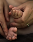 Close-up of hands gripping the handles of a baby-foot during an intense match.