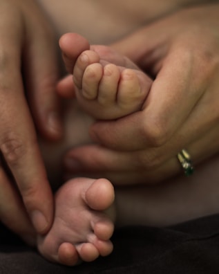 Close-up of hands gripping the handles of a baby-foot during an intense match.