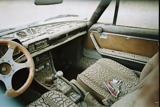 Worn and dirty car seat interior showing visible grime and dust before detailing.