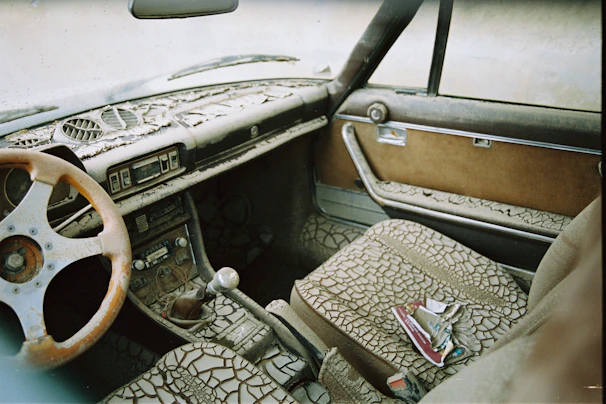 Worn and dirty car seat interior showing visible grime and dust before detailing.