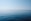 body of water under blue and white sky at daytime