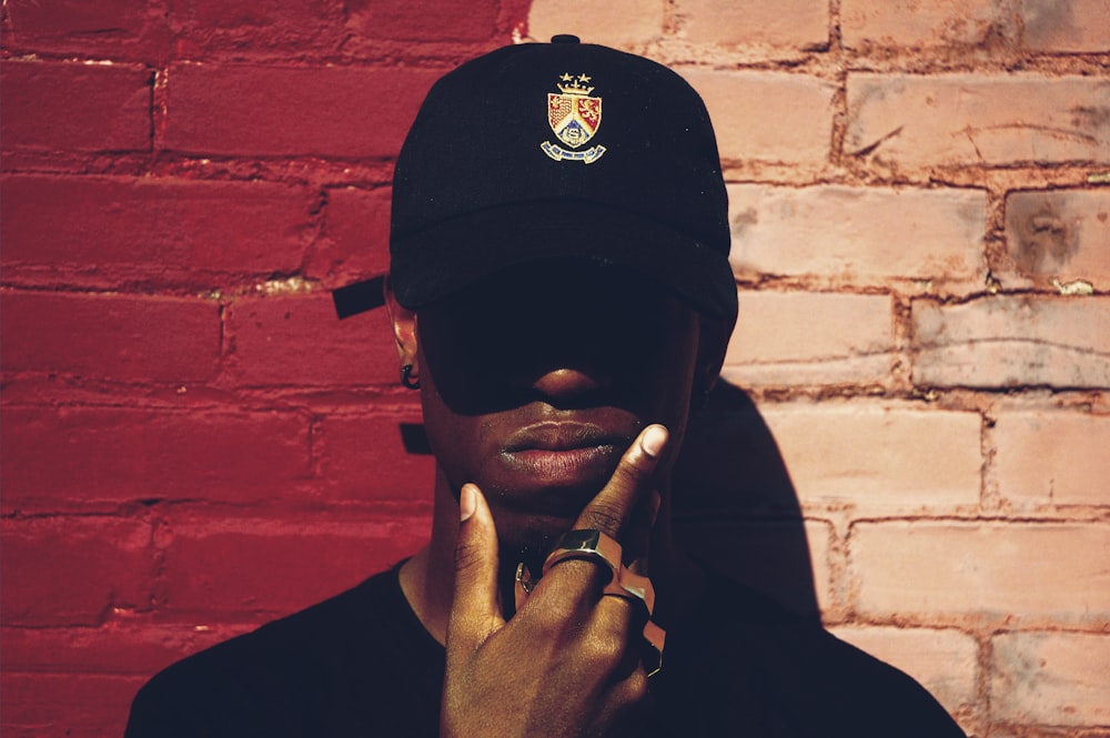 man with cap and background with red and pink wall l