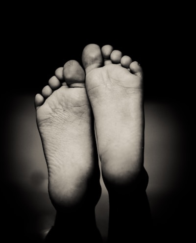 grayscale photo of human feet