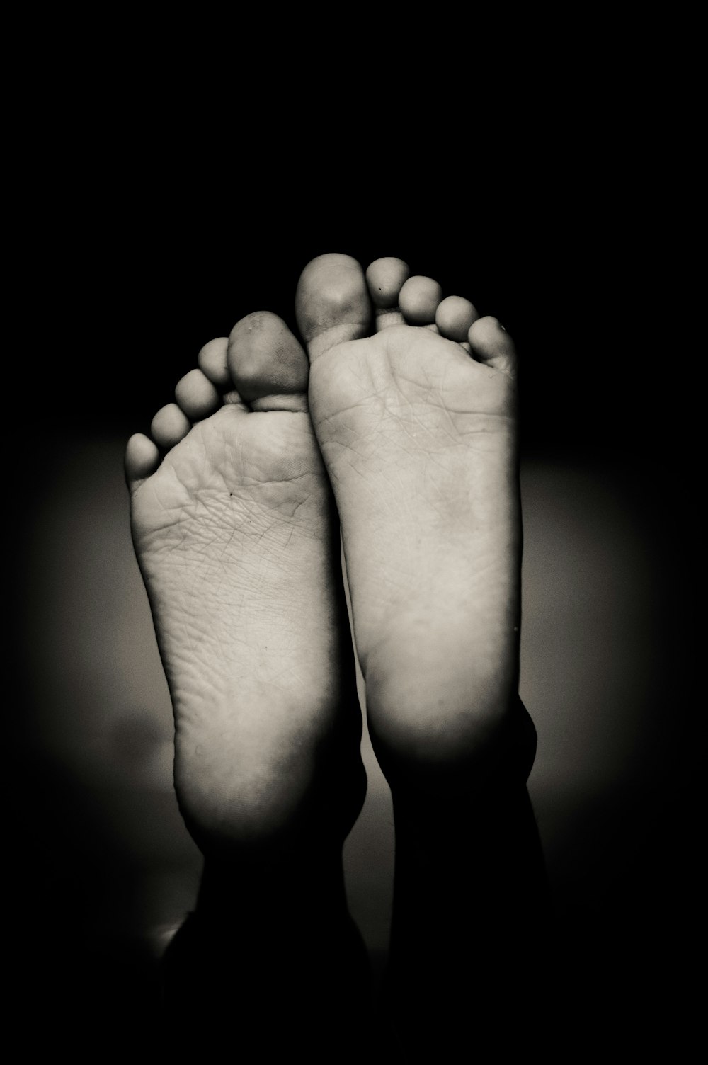 grayscale photo of human feet