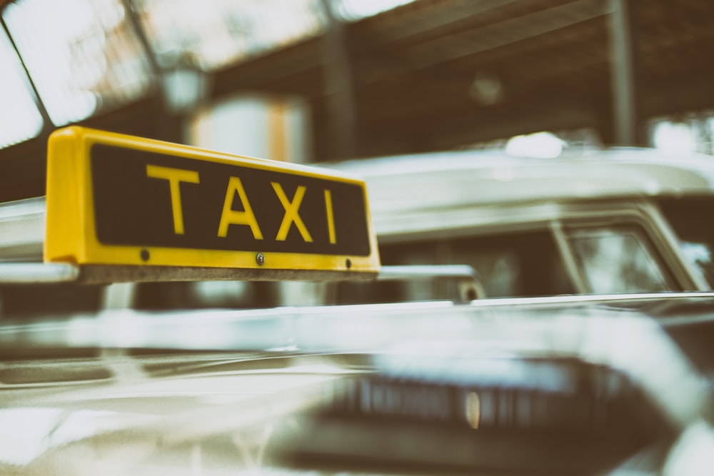 black and yellow Taxi signage