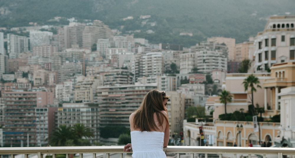 woman standing beside railings looking on her right