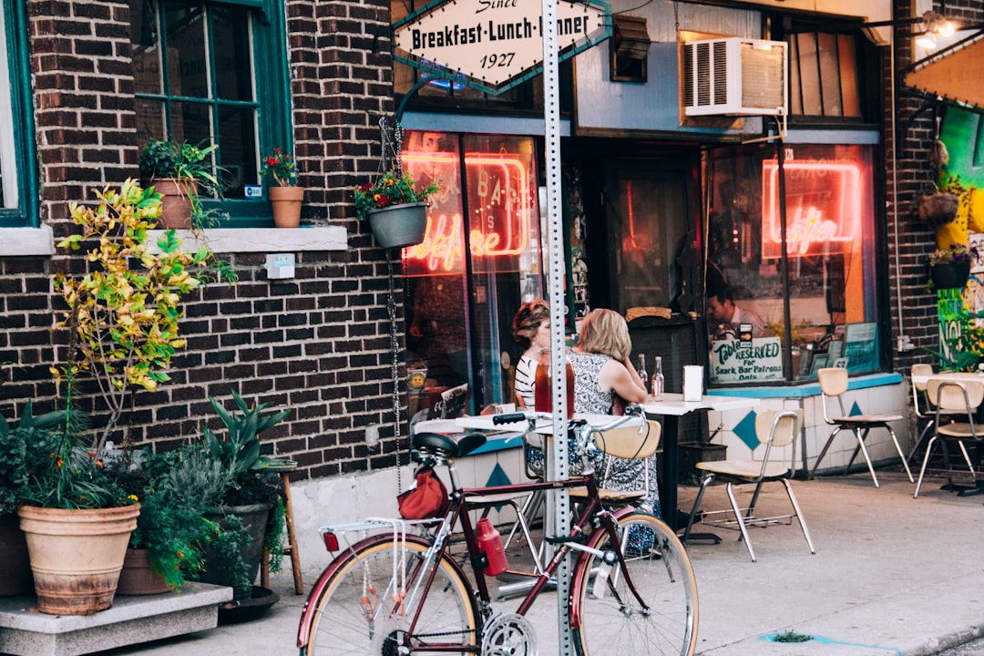 red bicycle park on gray road, Cozy café entrance