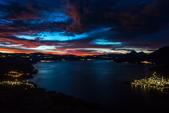 calm body of water near mountain during night time in San Pedro La Laguna Guatemala