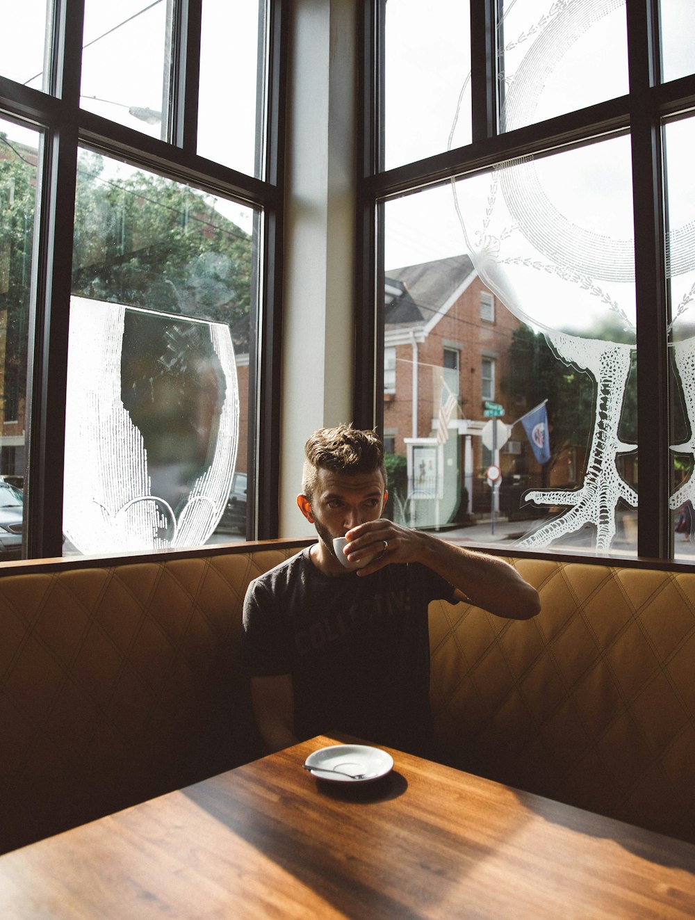 A man drinking coffee in the corner of a coffee shop in Cincinnati