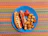Close-up of a colorful hotdog topped with mustard and relish, styled with retro diner elements.