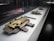 A display case holds a collection of intricate, antique locks and a key, reflecting historical craftsmanship with metalwork in a museum-like setting. The locks are ornate, featuring detailed engravings and a patina finish, with the key positioned prominently next to a lock.