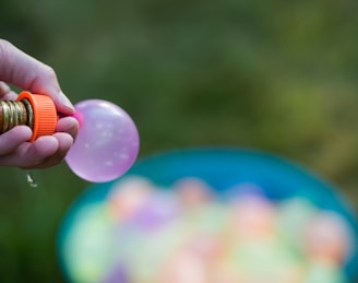 Close-up of a water rocket being filled carefully with water and air pressure.