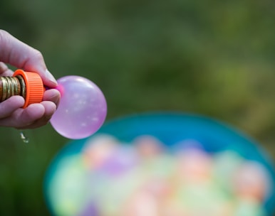 Close-up of a water rocket being filled carefully with water and air pressure.