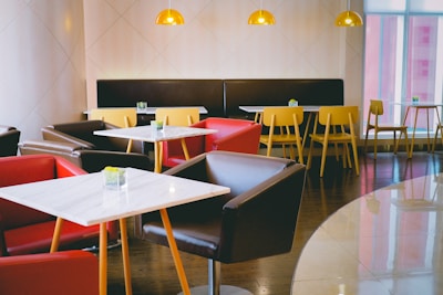 Bright yellow and red cafe interior with comfortable seating.