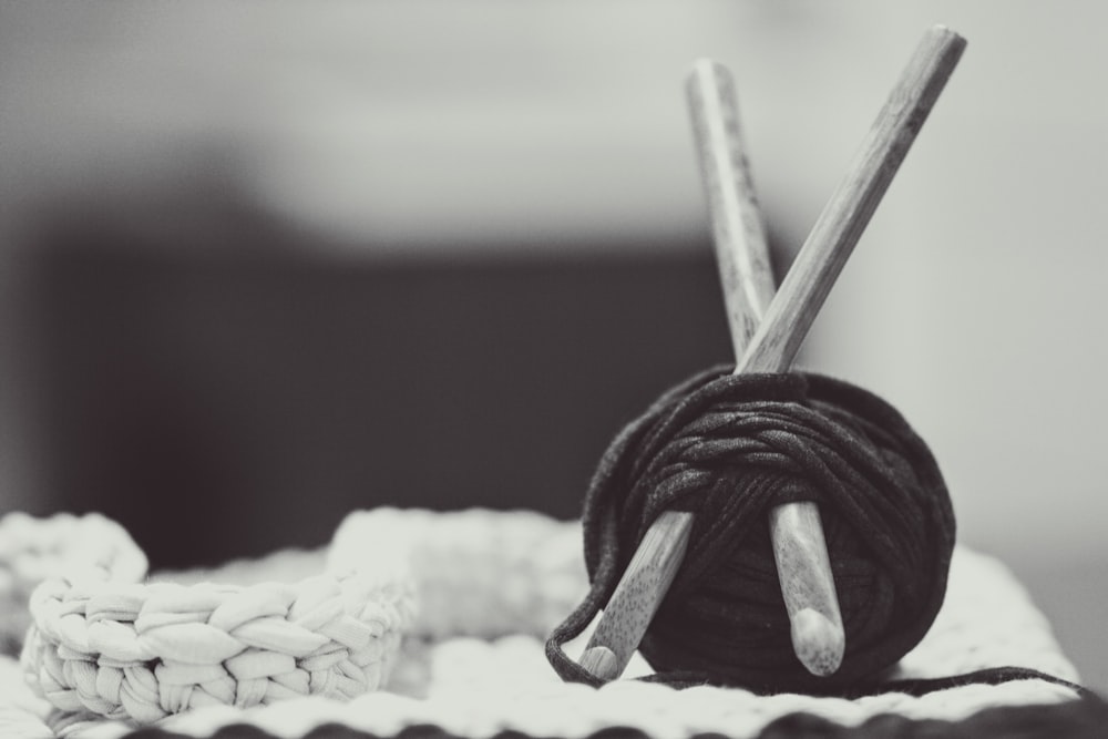 gray wooden sticks with black yarn