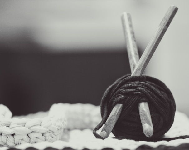 gray wooden sticks with black yarn