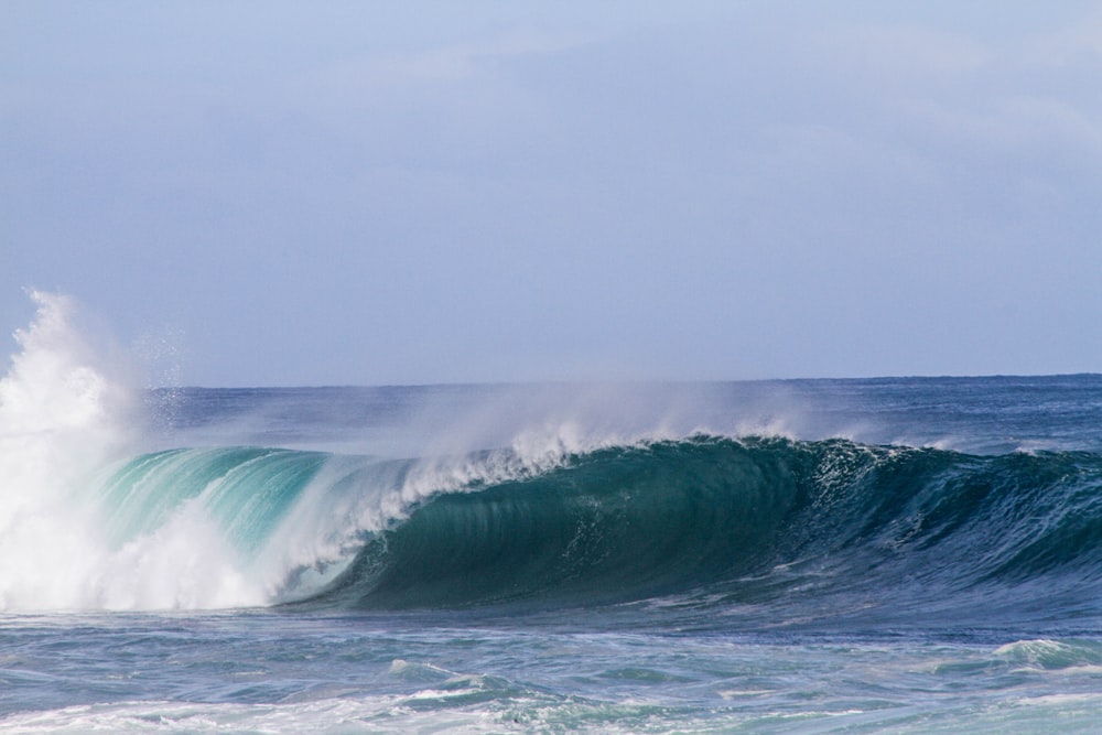 sea wave under gray clouds at daytime