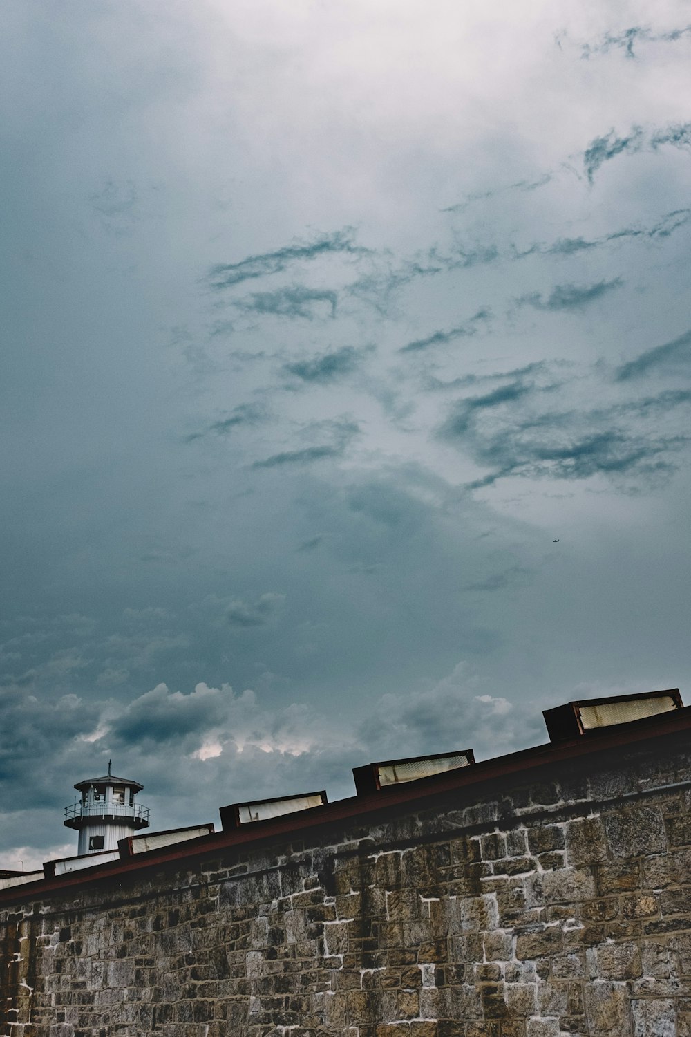 brown concrete building under cloudy sky during daytime