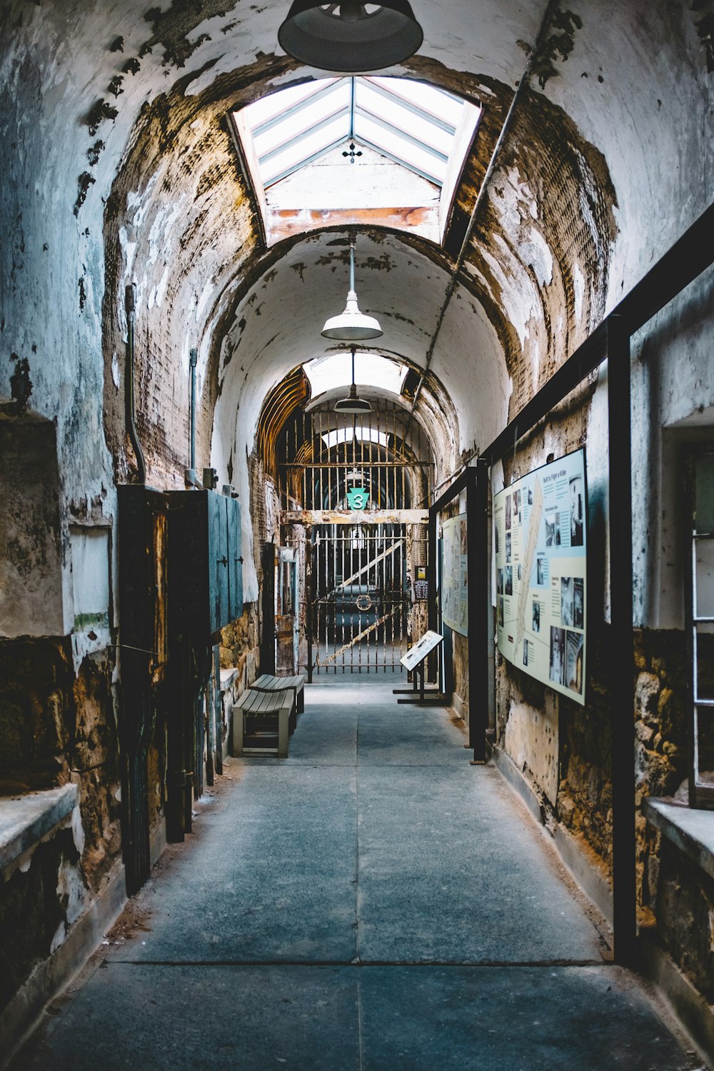 hallway with brick walls and windows