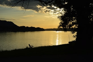 A quiet lakeside bench at sunset, evoking moments of reflection and clarity.