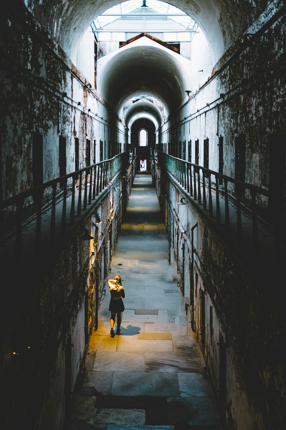 woman in black dress walking inside room