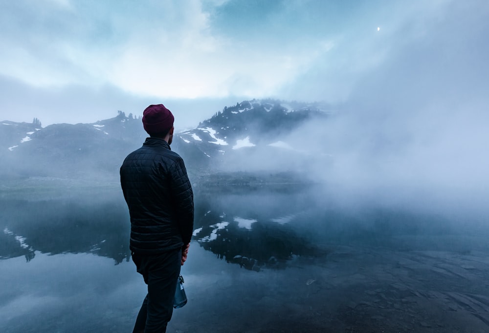 man standing near body of water