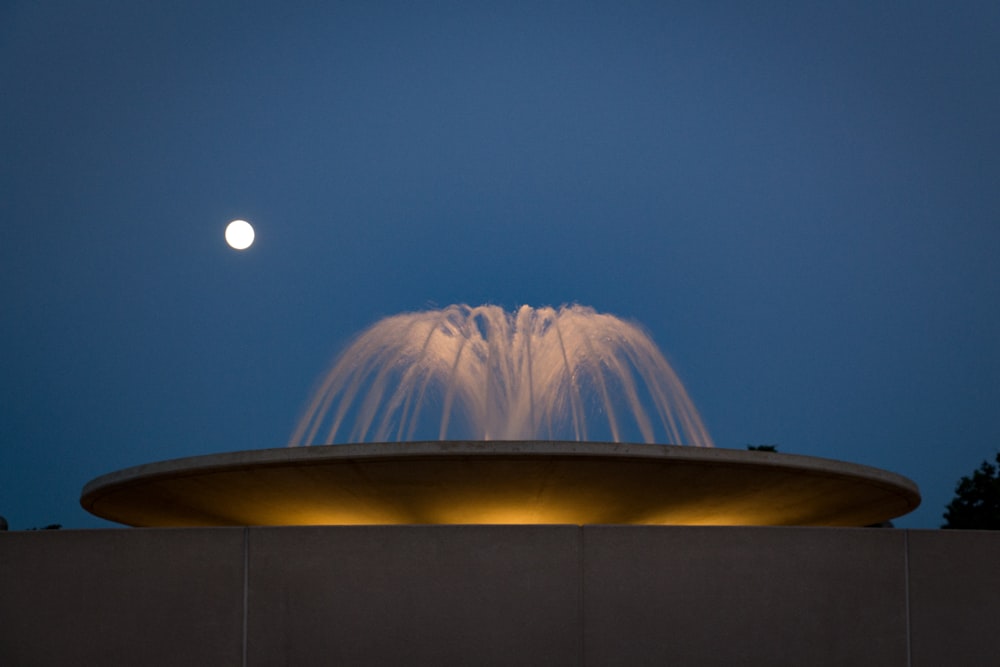 people standing near white building during night time