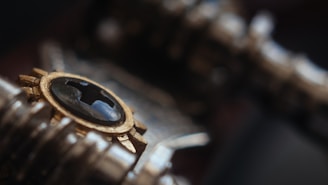 Close-up of a golden metallic almud measure blending with sleek black matte and circuit patterns.