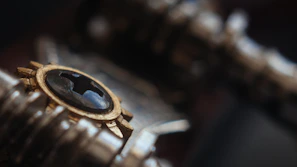 Close-up of a sleek gold detector accessory with gold and black accents on a dark background