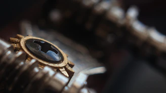 Close-up of a sleek gold detector accessory with gold and black accents on a dark background