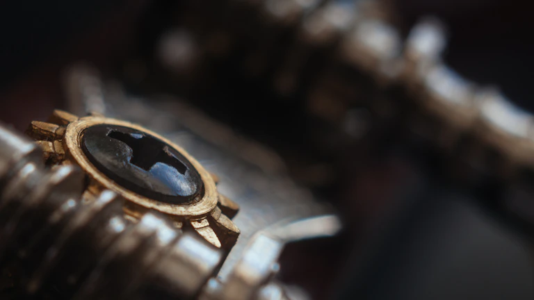 Close-up of a sleek, gold-accented 3D printed gear against a black background.