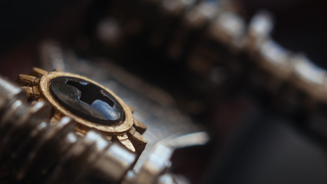 Close-up of a golden metallic almud measure blending with sleek black matte and circuit patterns.