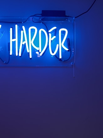 blue Work Harder neon signage