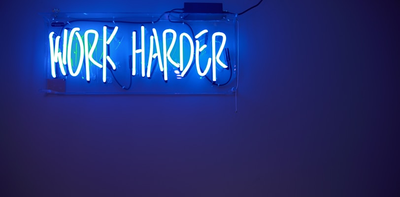 blue Work Harder neon signage