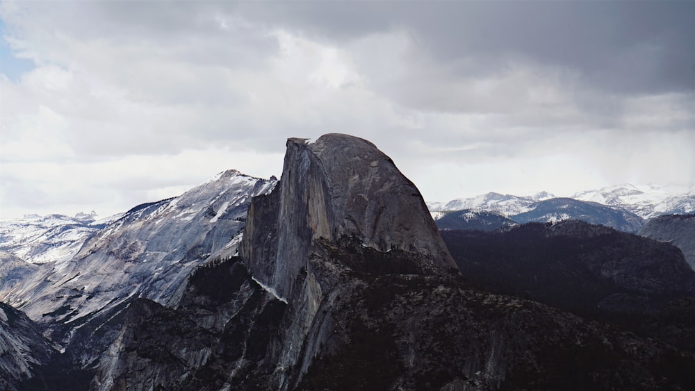 photo of black and white mountain with snow during daytime