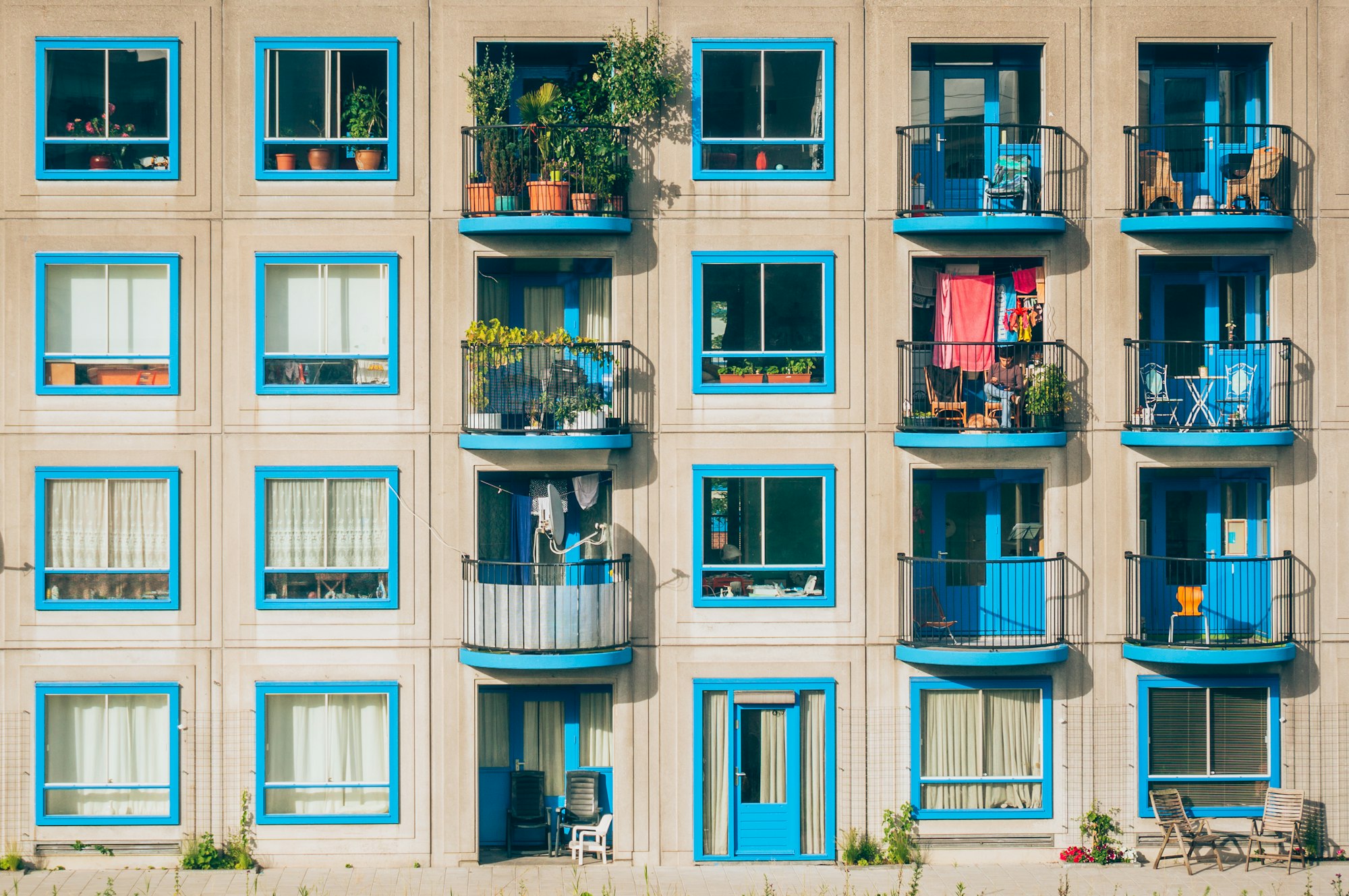 A snapshot of an apartment building with baby-blue colored window frames