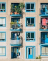 white and blue concrete 4-storey building