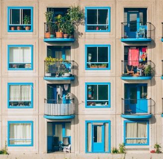 white and blue concrete 4-storey building