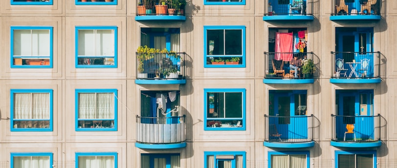 white and blue concrete 4-storey building