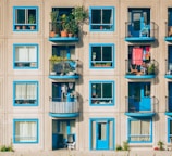 white and blue concrete 4-storey building