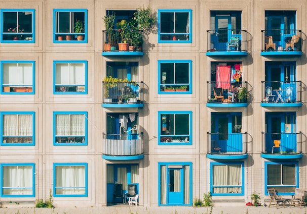 white and blue concrete 4-storey building