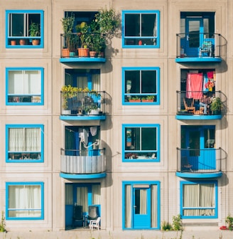 white and blue concrete 4-storey building