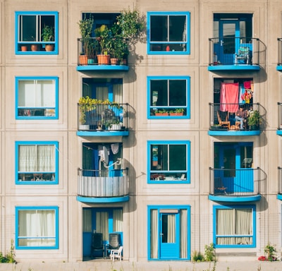 white and blue concrete 4-storey building