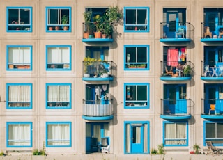 white and blue concrete 4-storey building