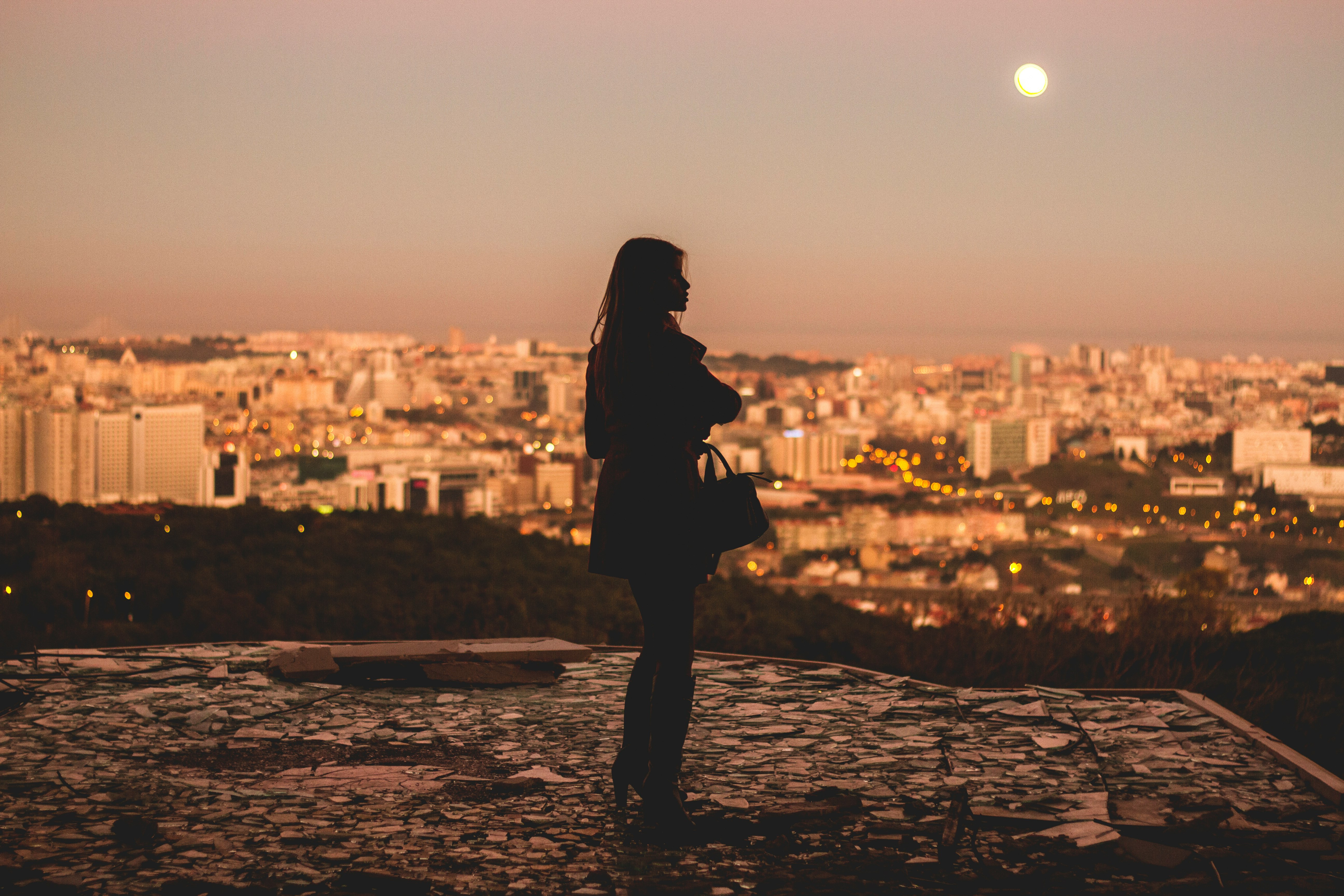 silhouette of woman standing during golden hour photography