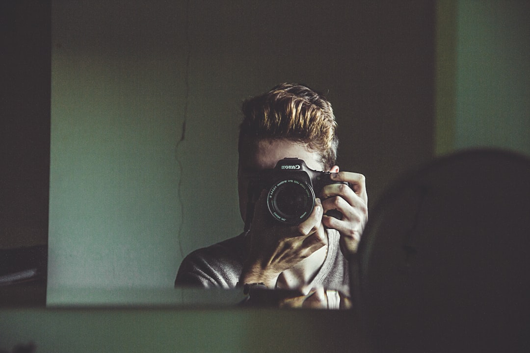 man taking photo on mirror