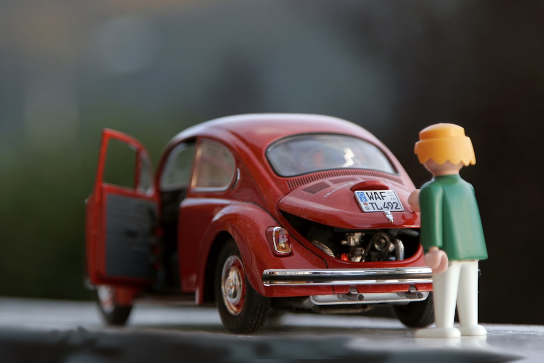 orange hair Lego toy looking at red beetle car, Red beetle toy car Playmobil