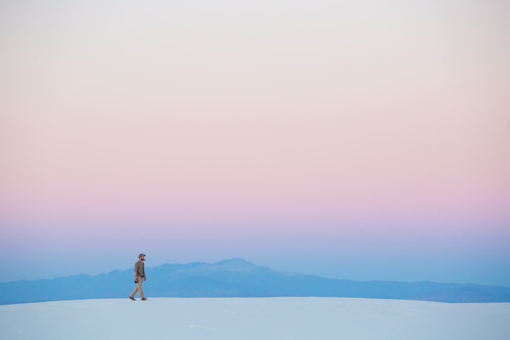 human walking on snow covered mountain