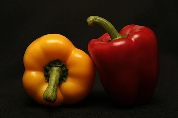 Two red and orange bell peppers