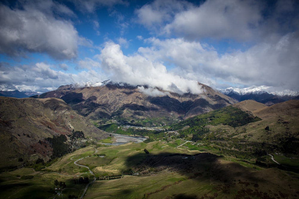 mountains under cloudy skies at daytime